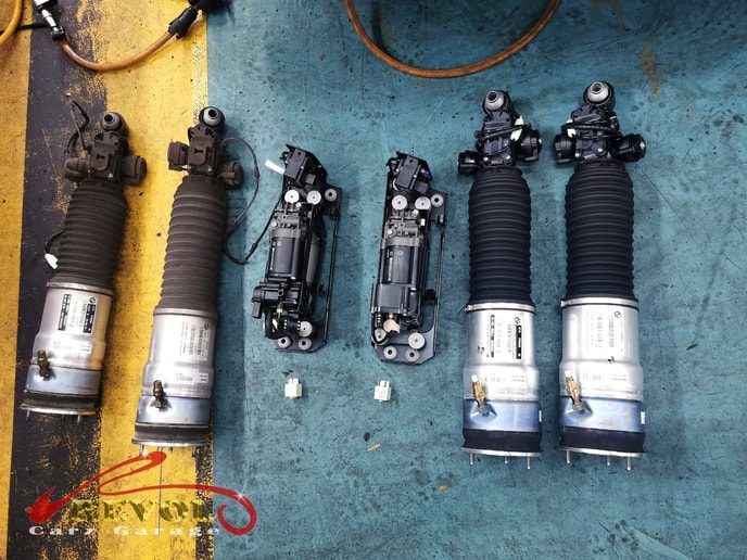 The worn rear air strut and air pump removed professionally.
