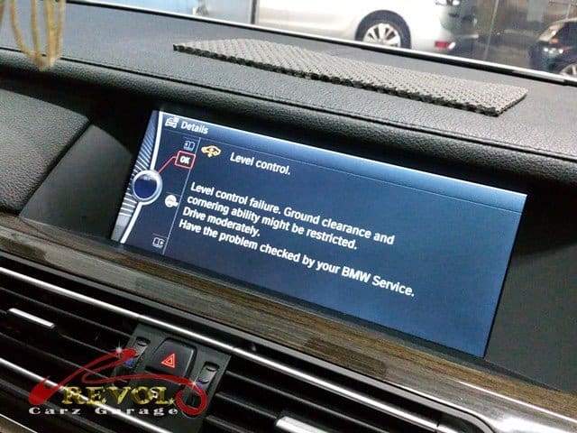 The BMW 7 Series checked, sitting unevenly with the air suspension warning.