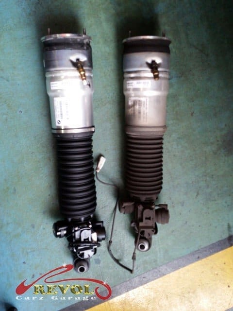 The worn air strut removed, the rubber bag perished and leaking.
