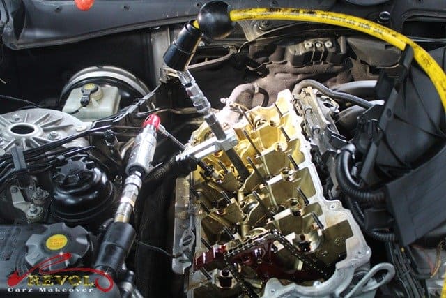 Removing the hardened valve stem seals with the correct special tools.