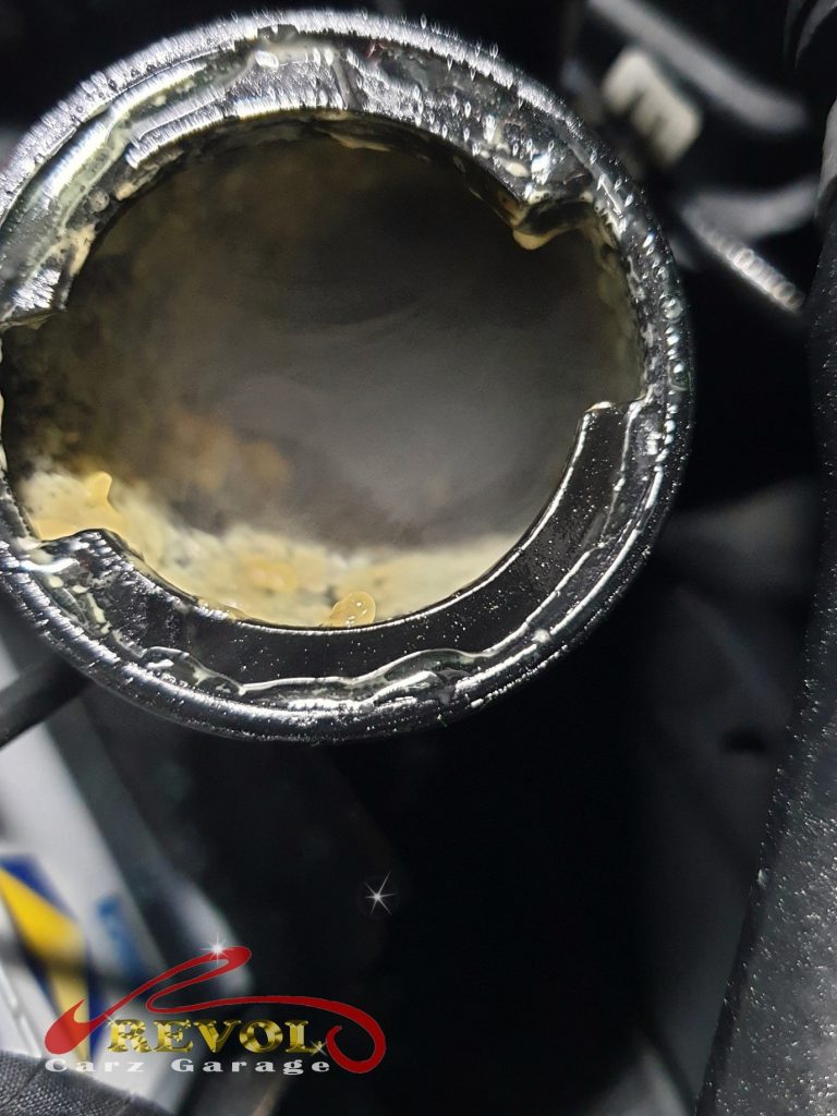 The failed engine oil cooler removed, the internal wall breached.