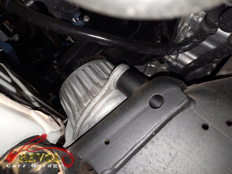 The transmission mount removed showing the play under load.