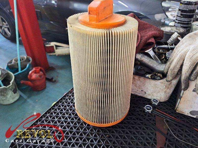 The old clogged engine air filter removed from the Mercedes-Benz C180.