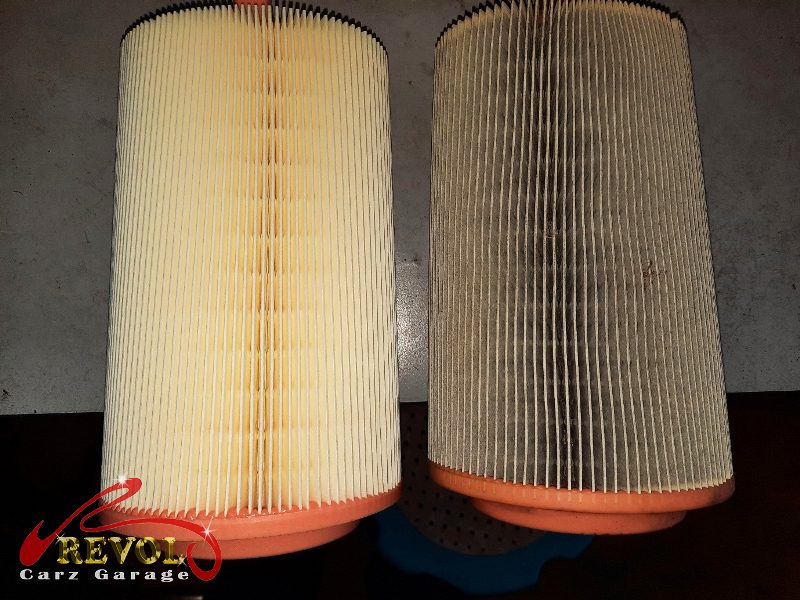 The old cabin filter pulled out, loaded with dust.