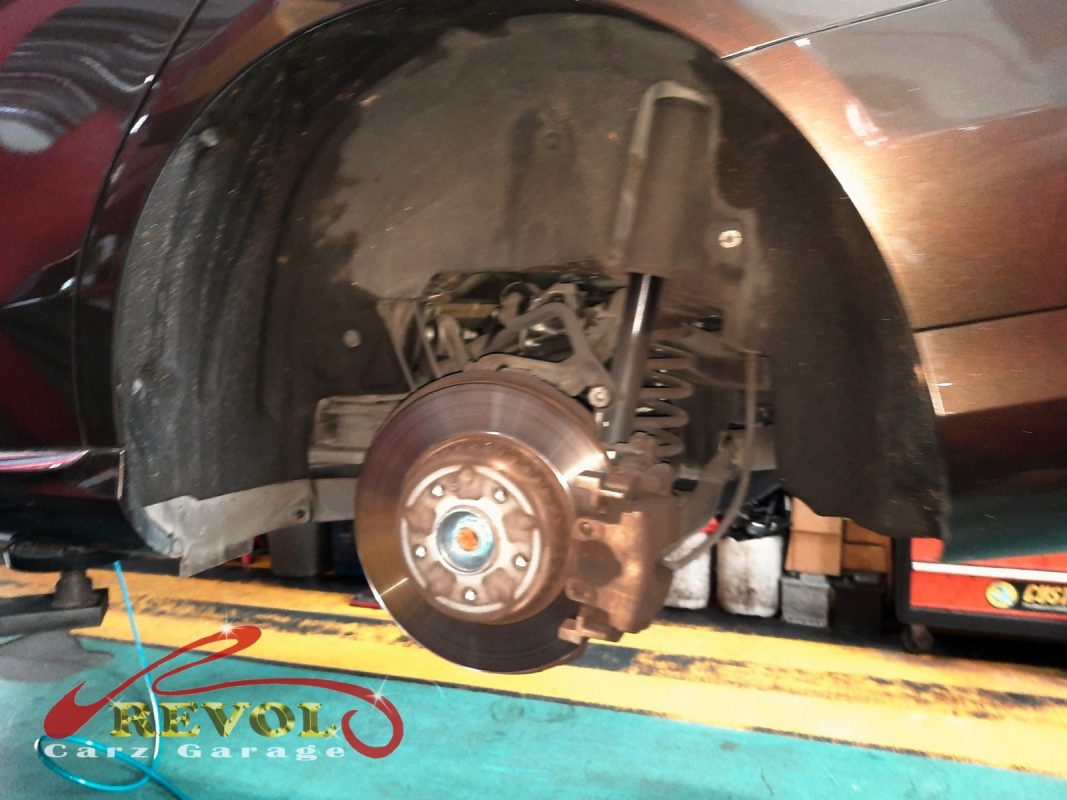 The worn rear brake pads on the Mercedes-Benz C180, down to the wear marker.