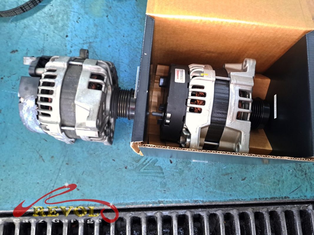 The old alternator removed from the engine.