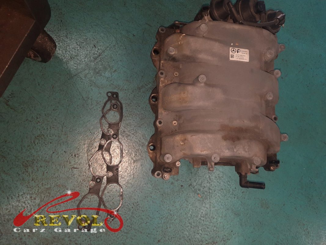 The old intake manifold removed from the engine.