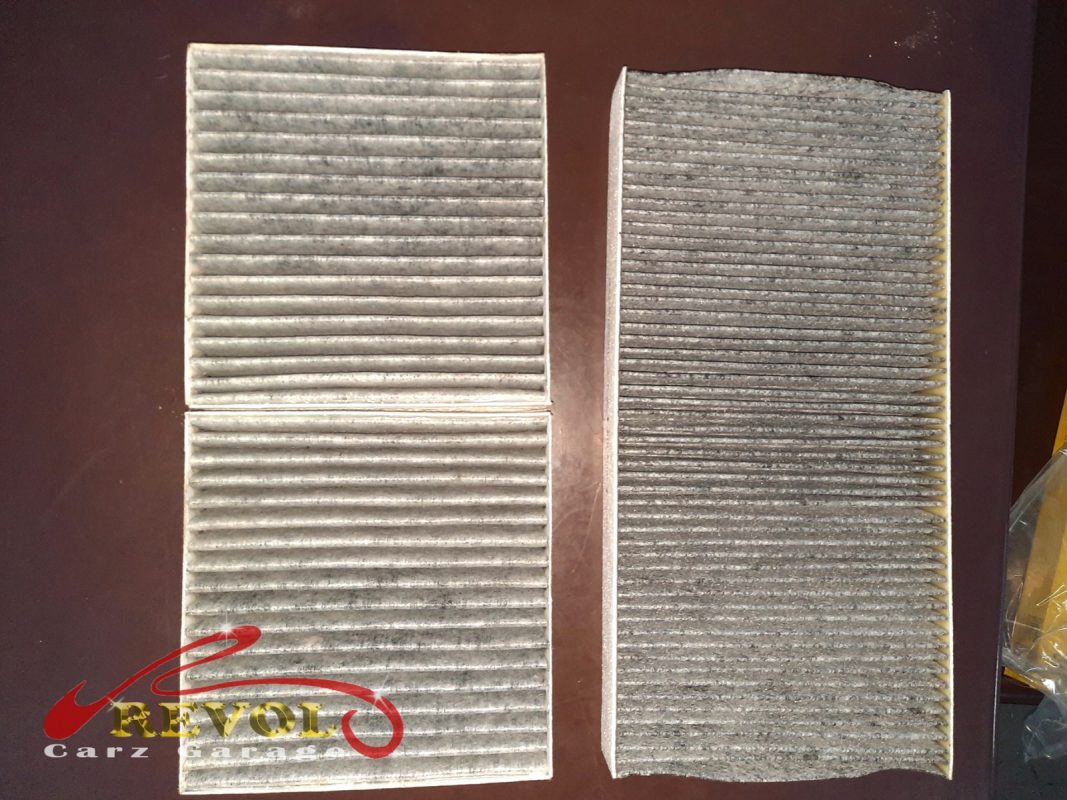 The old air filter beside the new Mercedes-spec replacement.