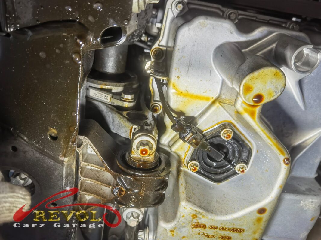 The oil filter housing removed and the old hardened gasket exposed.