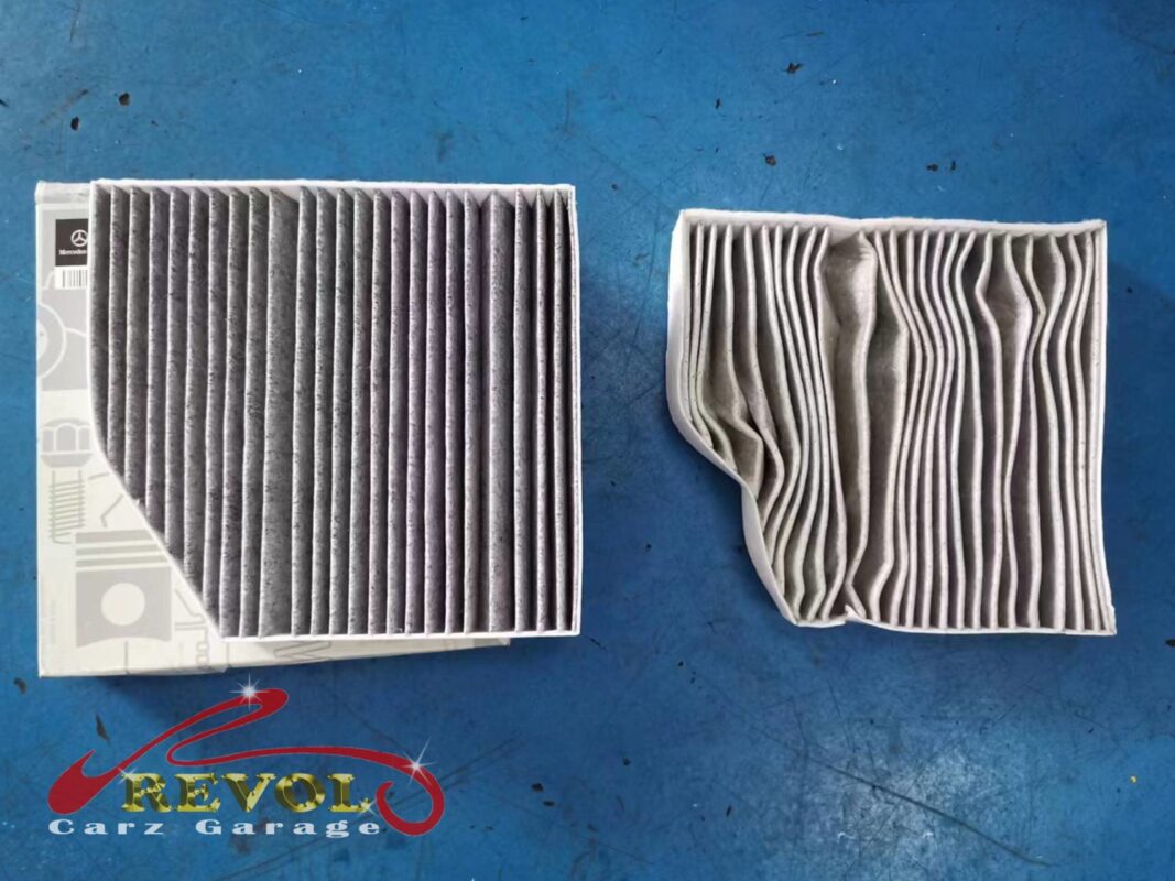 The old air filter beside the new Mercedes-spec replacement.
