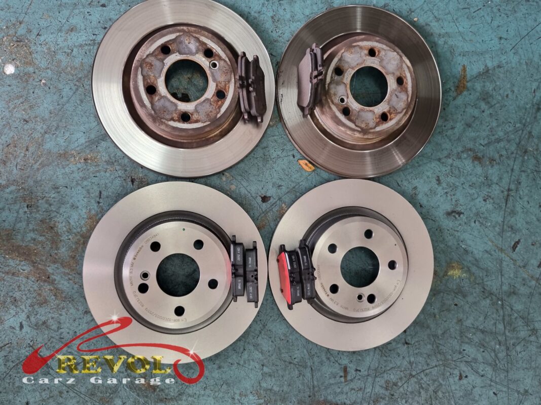 The worn front disc beside the new Mercedes-spec rotor.