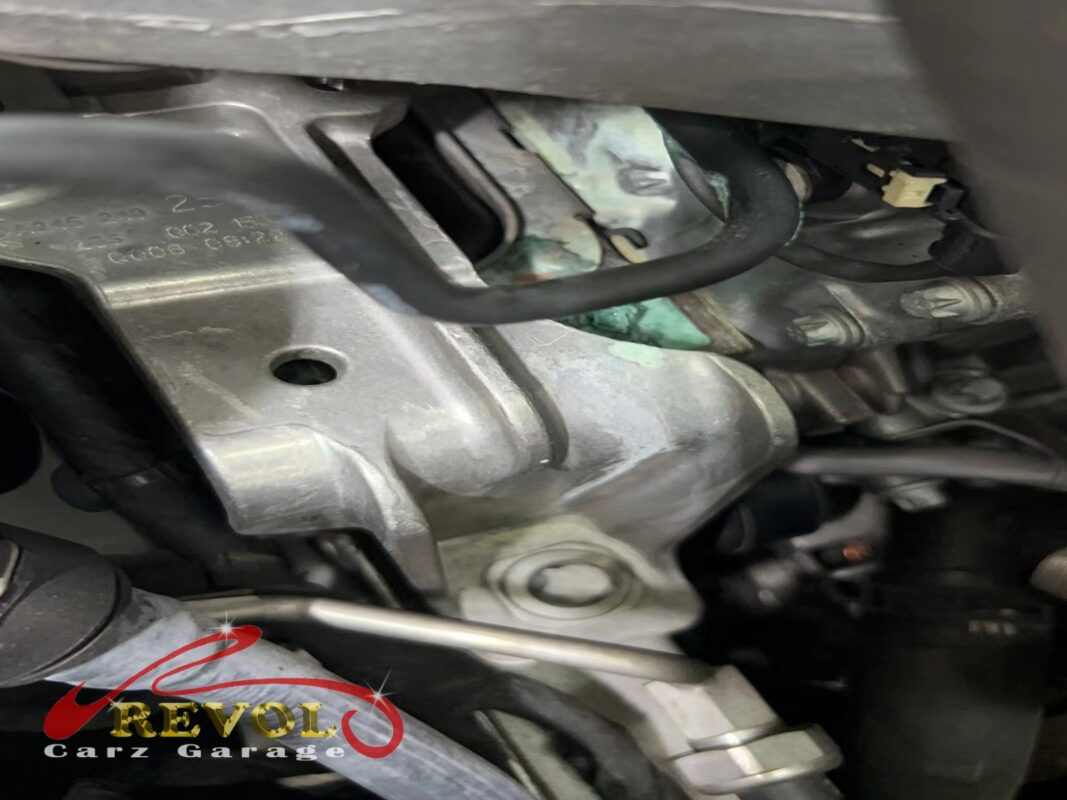 The old cracked thermostat housing removed from the engine.