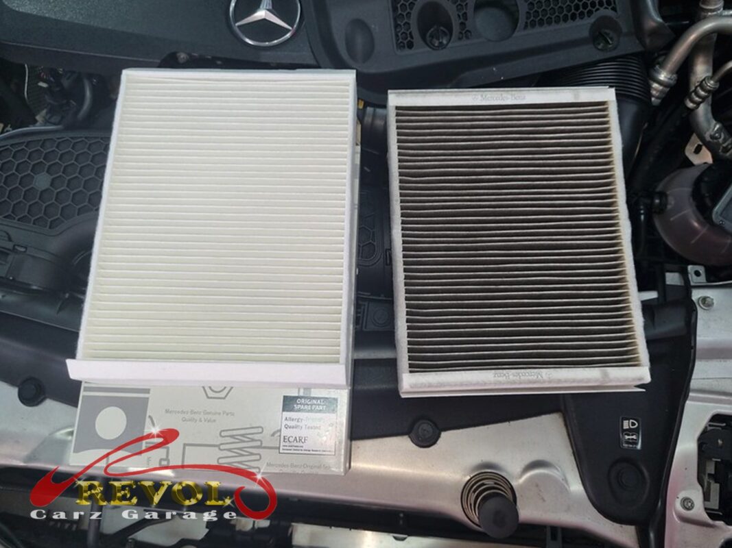 The old air filter beside the new Mercedes-spec replacement.