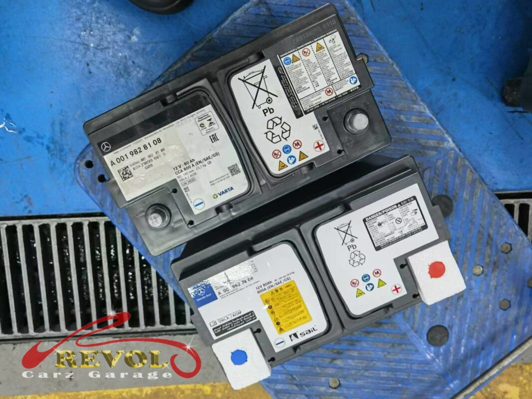 The old battery removed beside the new correct-spec replacement.
