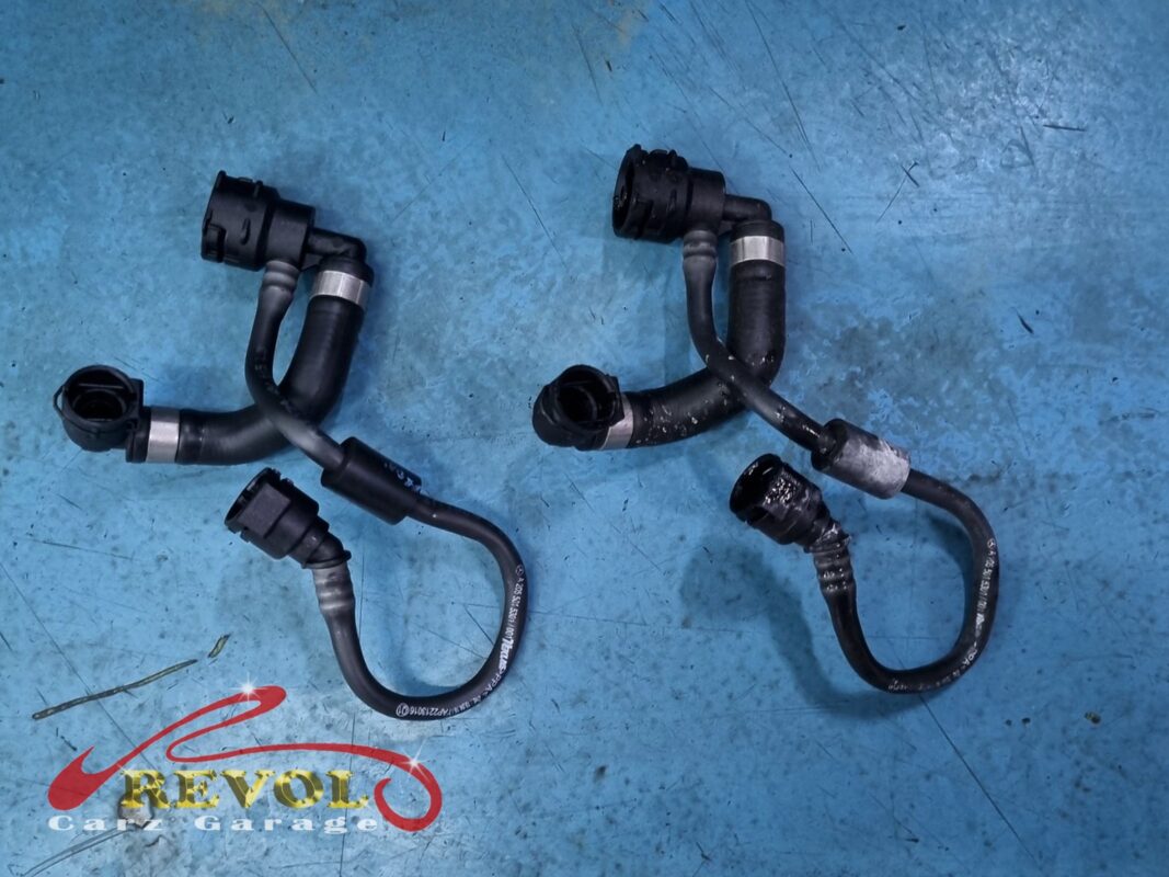 The old cracked thermostat housing removed from the engine.