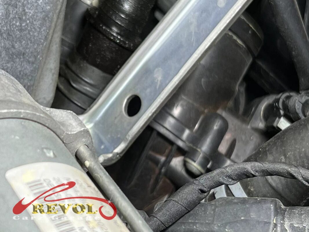 The old thermostat housing removed from the engine.