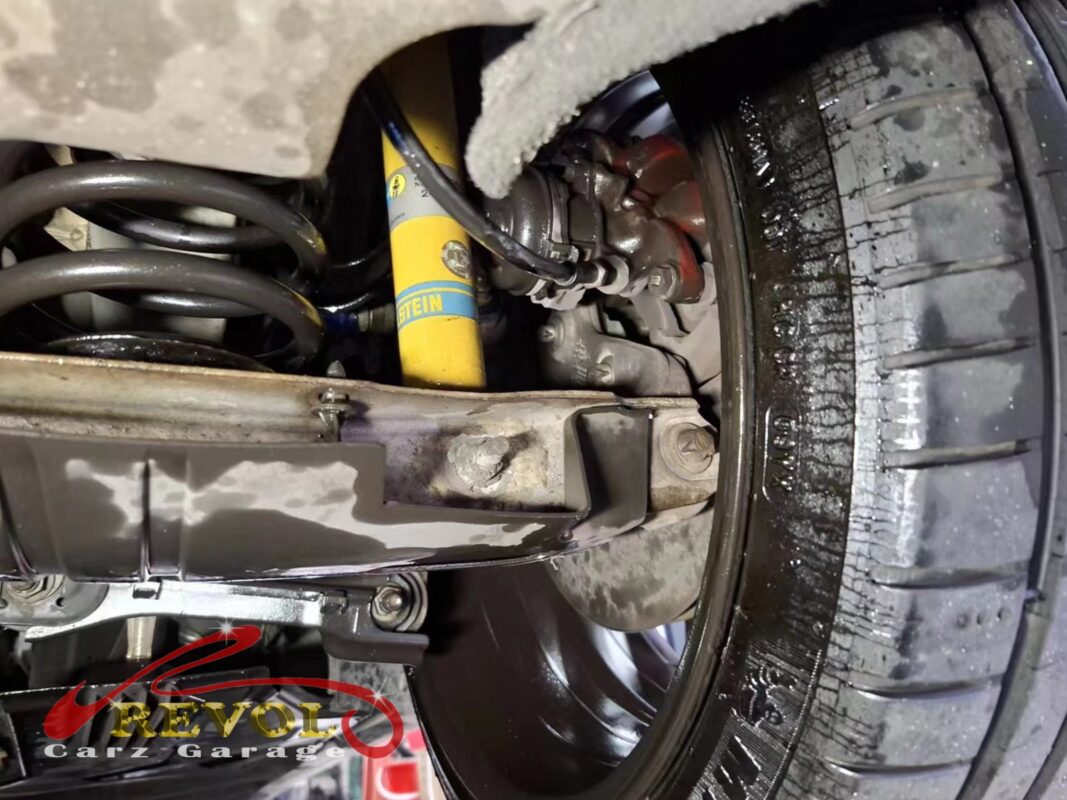 The wheel removed, the calliper and the flexible brake hose exposed for inspection.