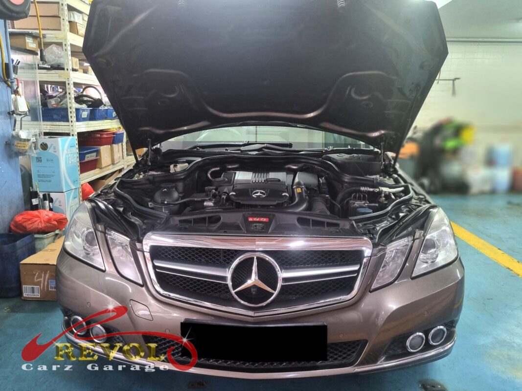 Mercedes-Benz E200 on the lift for control and lower arm replacement.