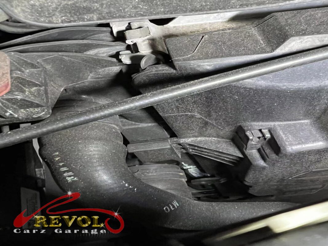 The cooling-system hoses at the front of the engine, checked for the source of the loss.
