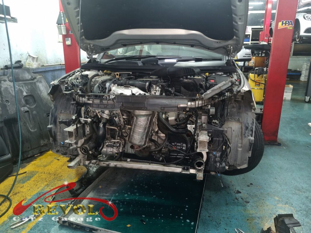 The front of the CLA opened up, the bumper off and the cooling stack exposed for the radiator job.