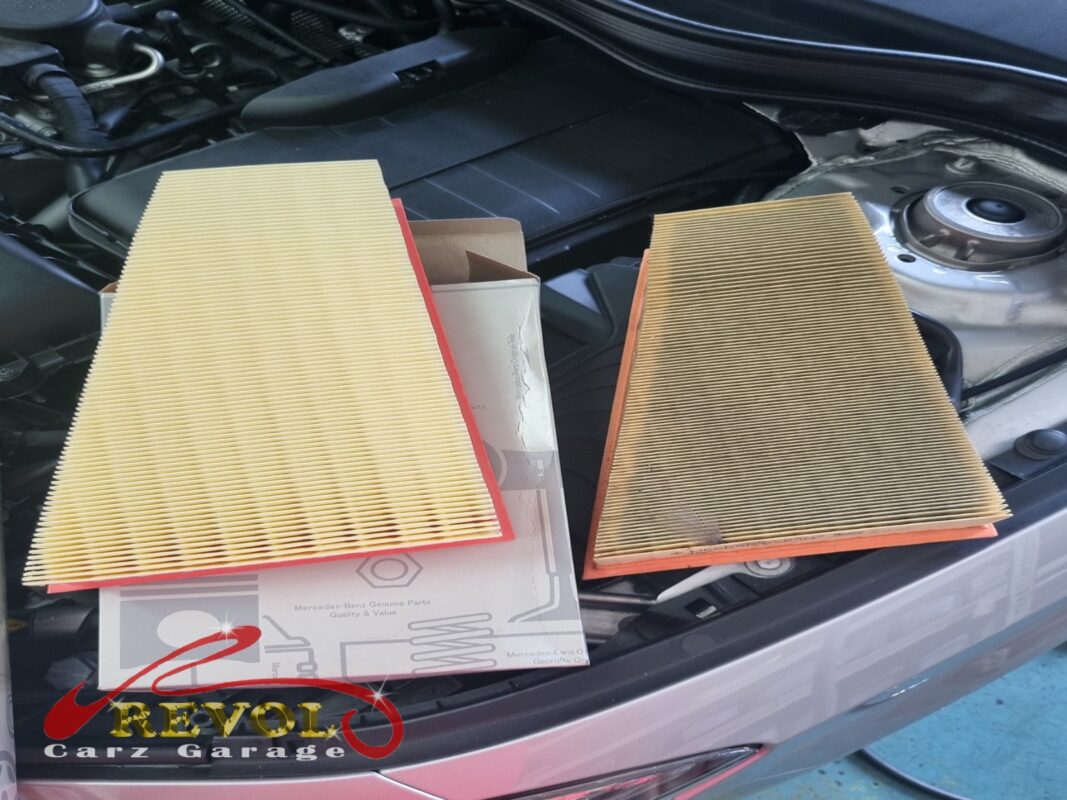 The clogged old engine air filter (right) next to the new Mercedes-spec replacement (left).