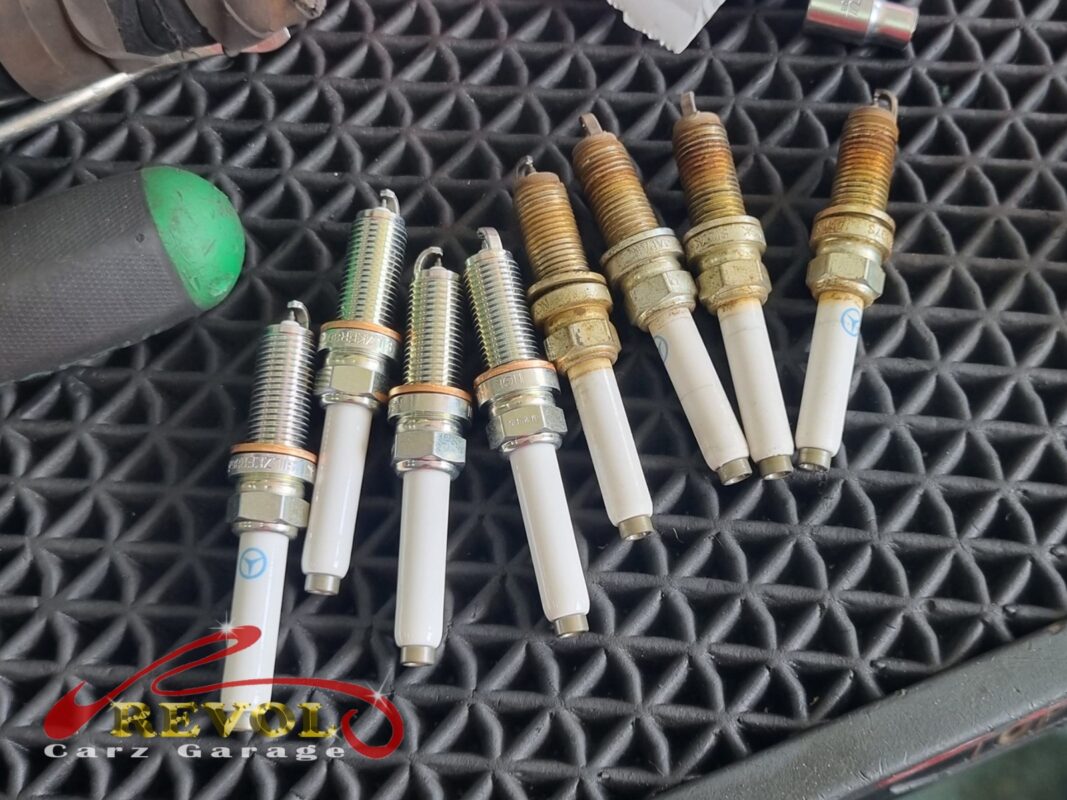 The old spark plugs (right) beside the new Mercedes-spec set (left).