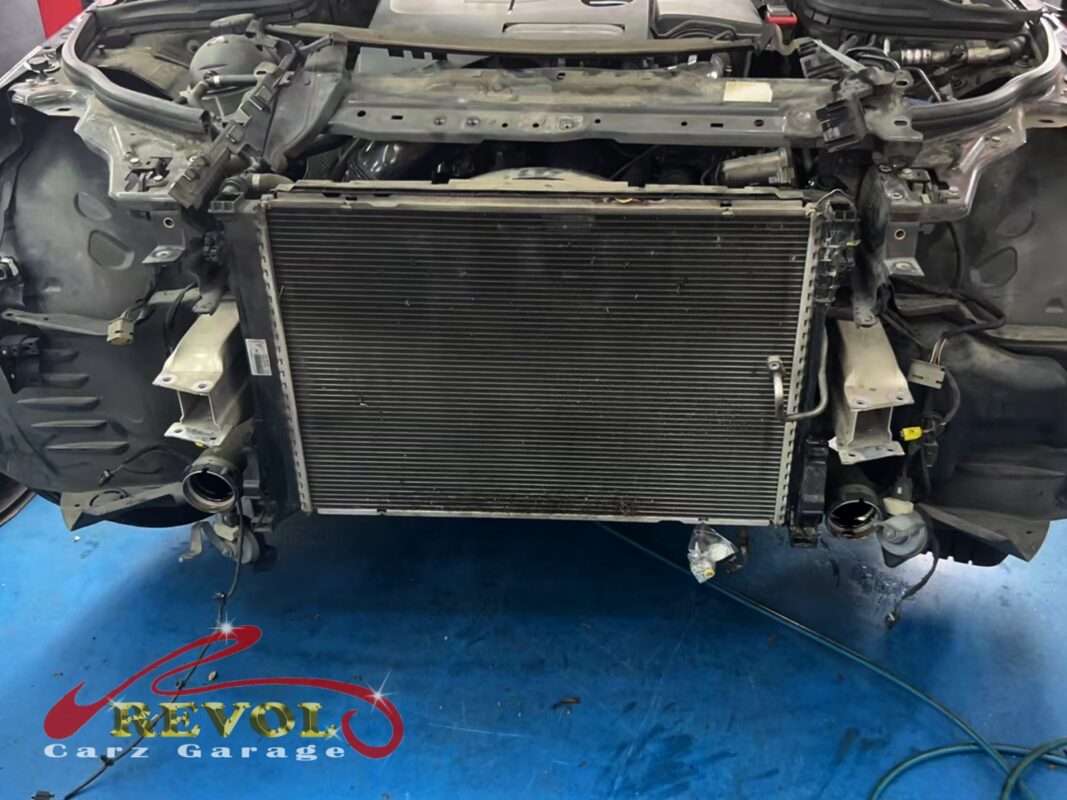The front of the C180 opened up, the radiator exposed in its mounts for replacement.