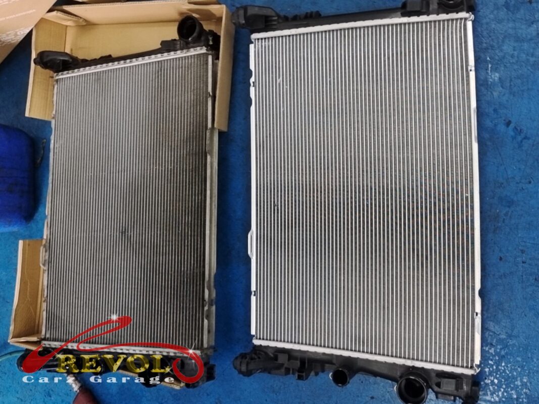 The old radiator (left, grimy) beside the new Mercedes-spec replacement (right).