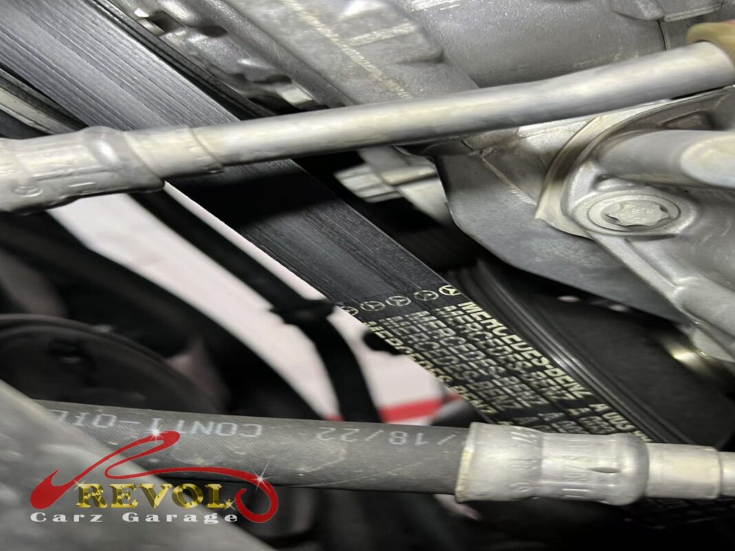 The accessory belt on the engine, the ribbed face glazed and starting to crack.