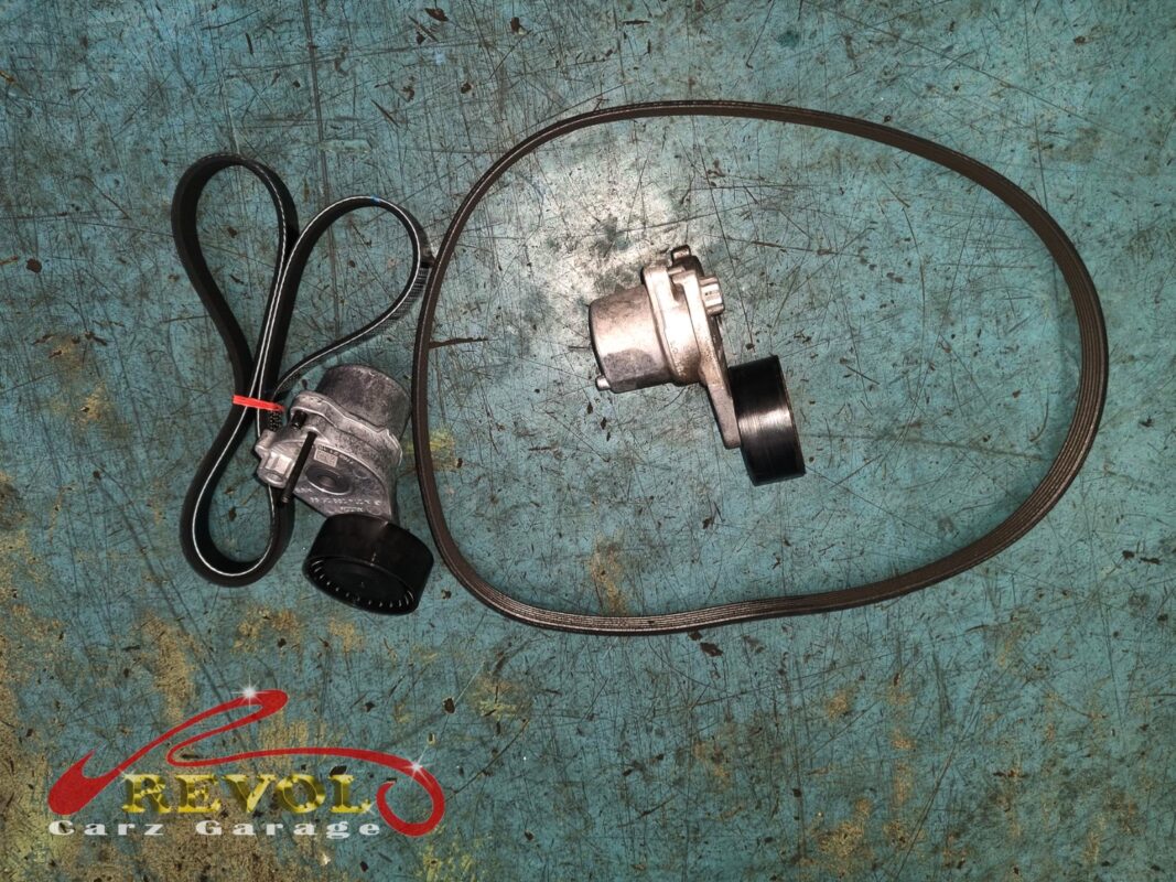 The old belt and tensioner (left) beside the new Mercedes-spec tensioner (right).