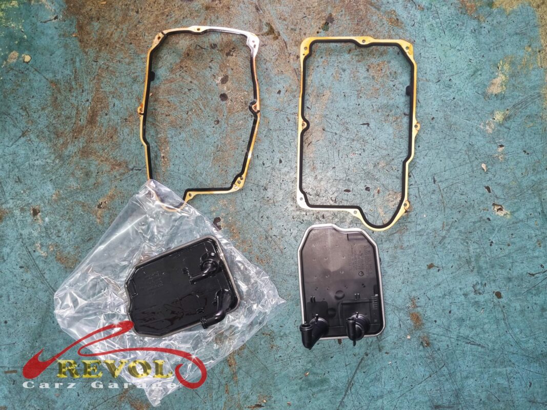 The new Mercedes-spec ATF filter and pan gasket beside the old filter removed.