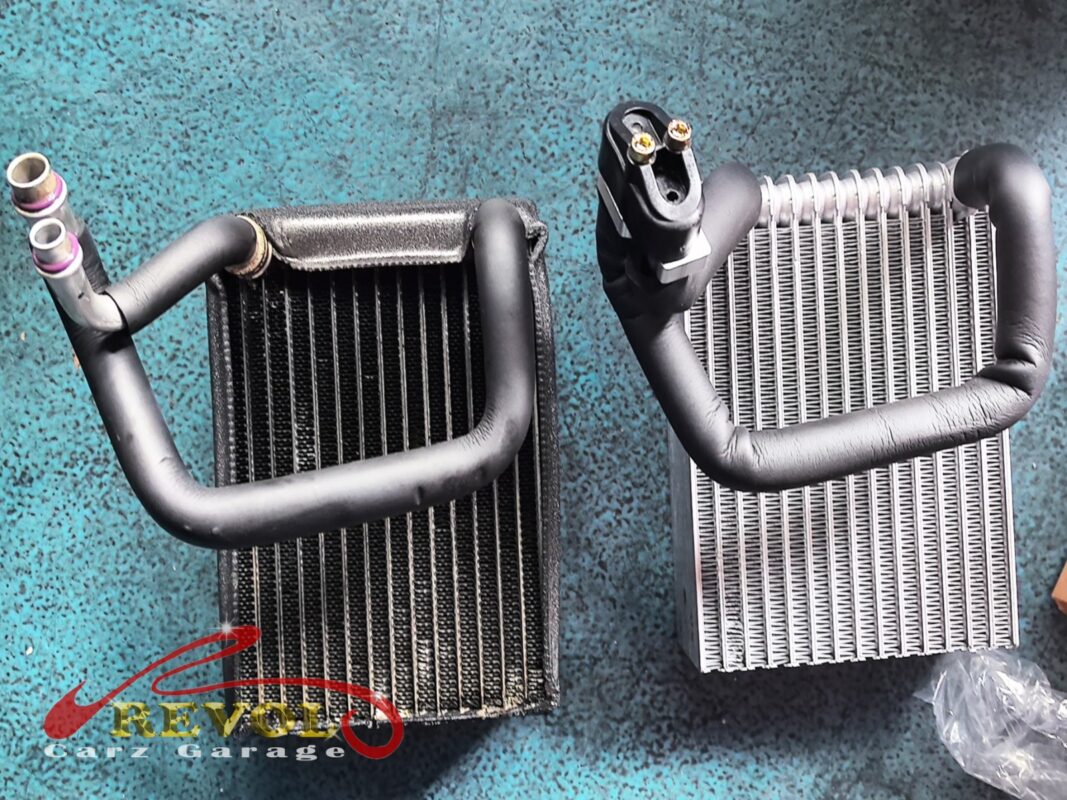 The old rear cooling coil (left, grimy) beside the new Mercedes-spec replacement (right).