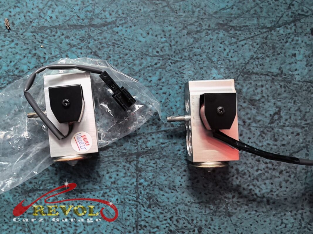 The new rear expansion valve (left, bagged) beside the old one removed (right).
