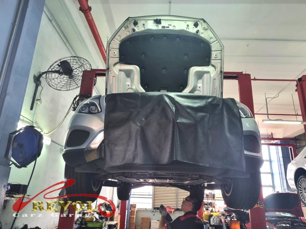 The car up on the two-post lift, in for the rough idle and hard cold starts.