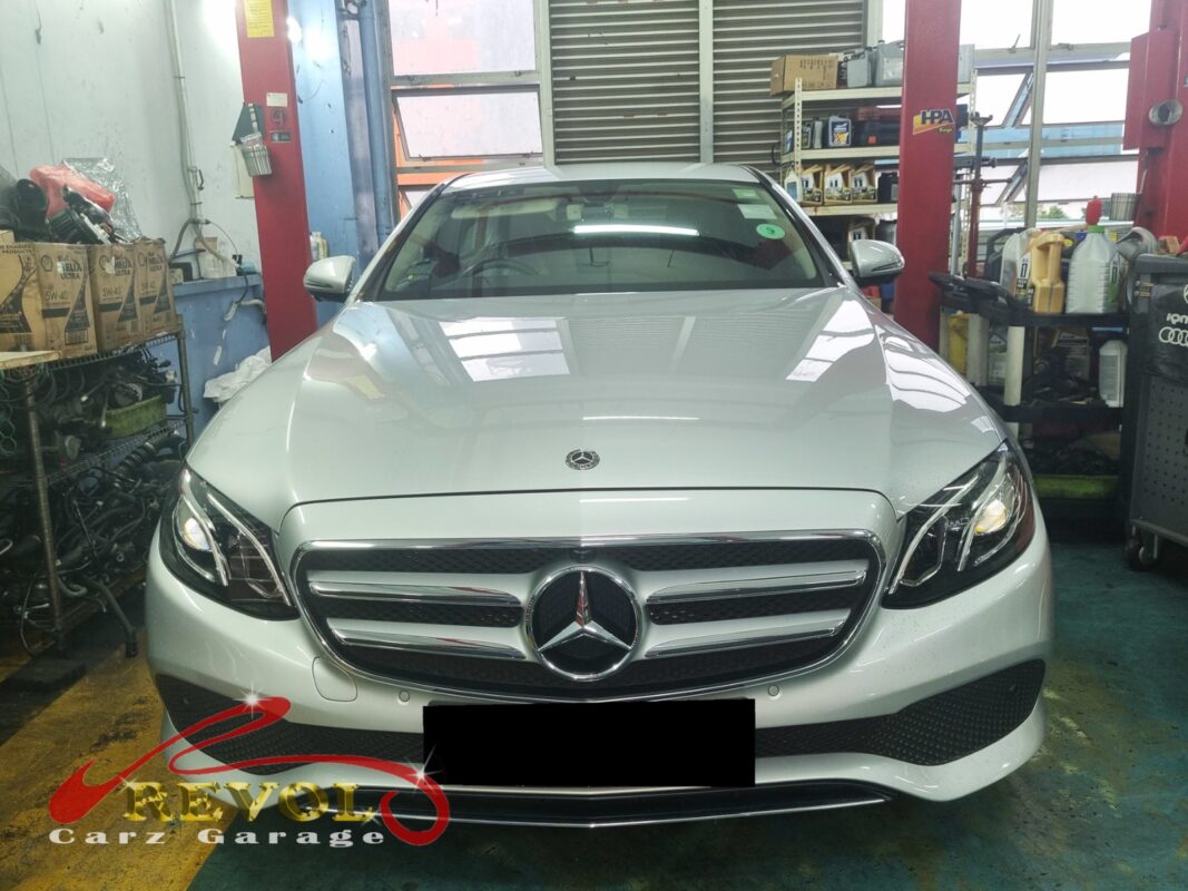 Mercedes-Benz E250 with the engine bay open for coolant pump replacement.