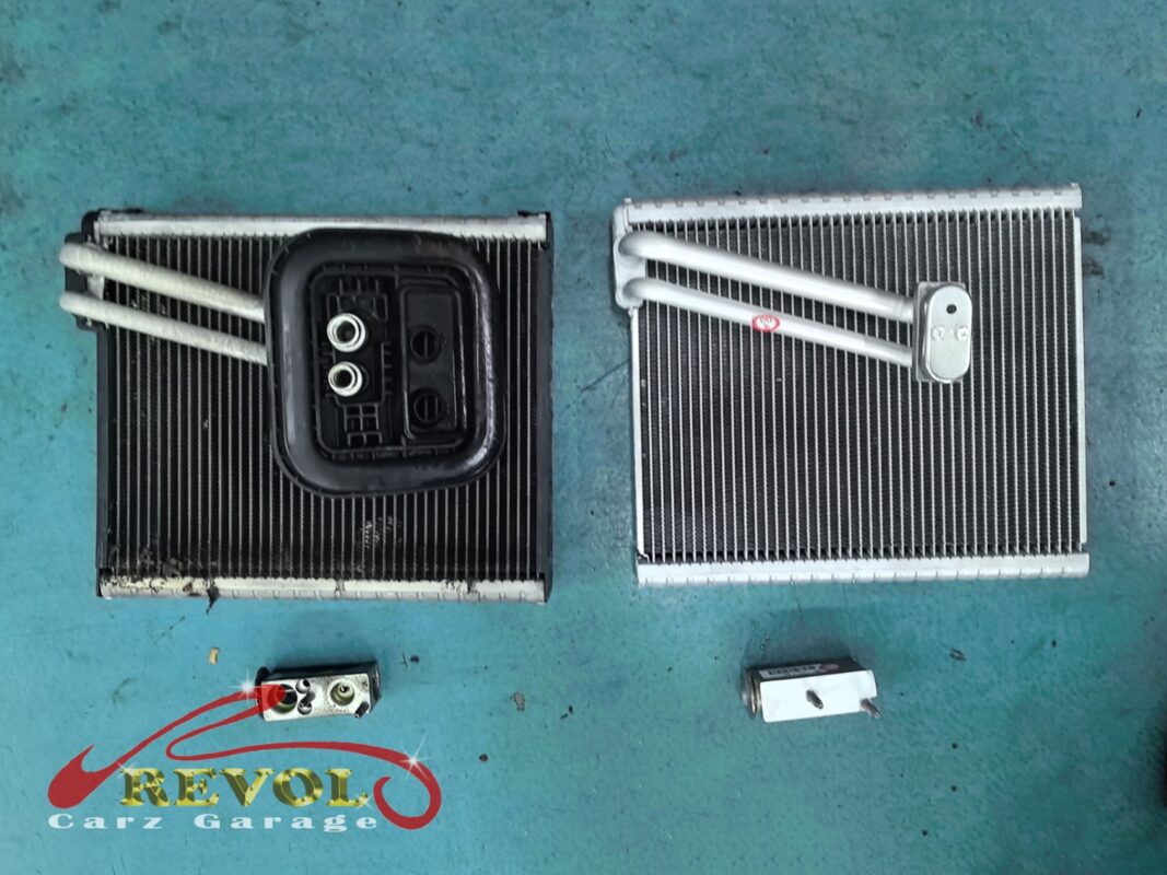 The old evaporator core (left, fins grimed over) beside the new Mercedes-spec core (right), with the old expansion valve and its new replacement below.
