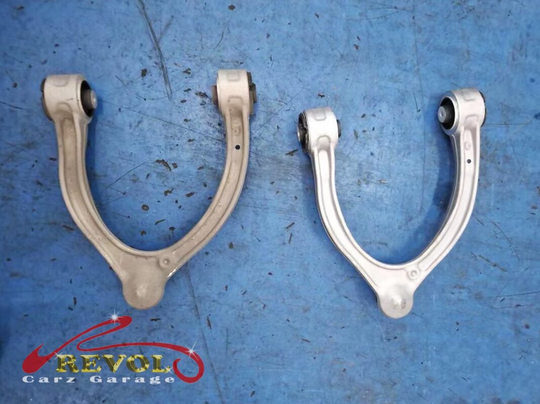 The matched pair of new Mercedes-spec upper control arms, fresh ball joints and bushes, ready to fit.