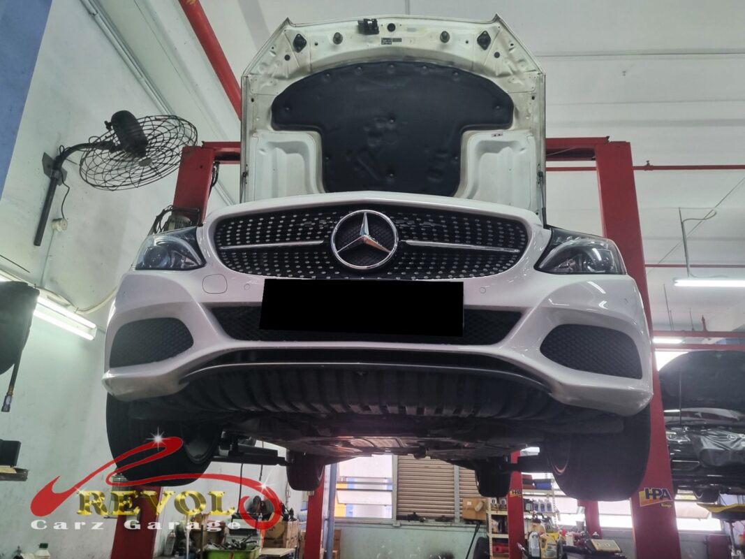 The C180 up on the two-post lift, hood open, in for the weak air-con.