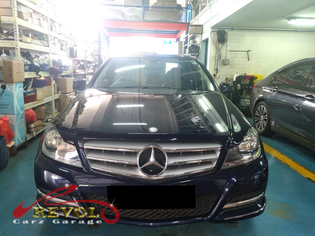 Mercedes-Benz C180 on the workshop lift for rear shock absorber set replacement.