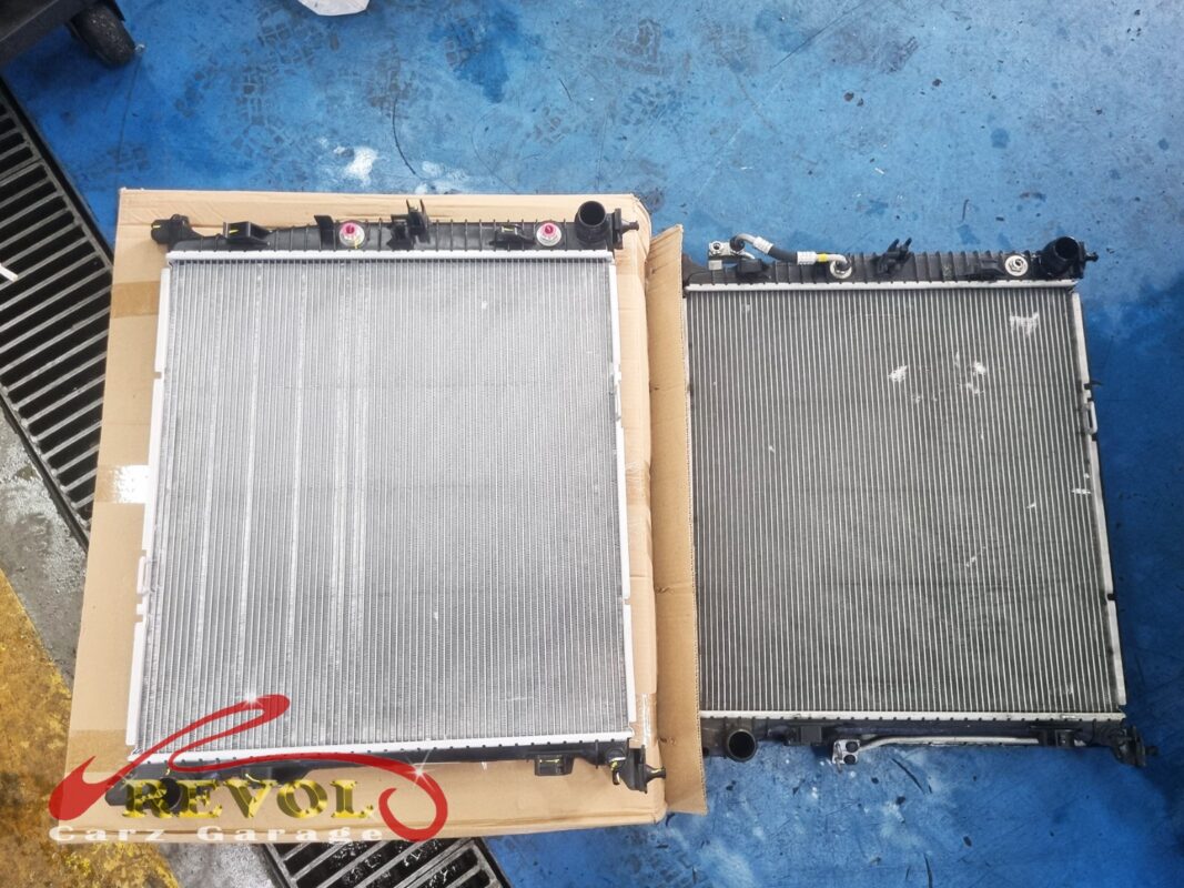 The new Mercedes-spec radiator (left, in its packaging) beside the old unit removed from the GLE400 (right).