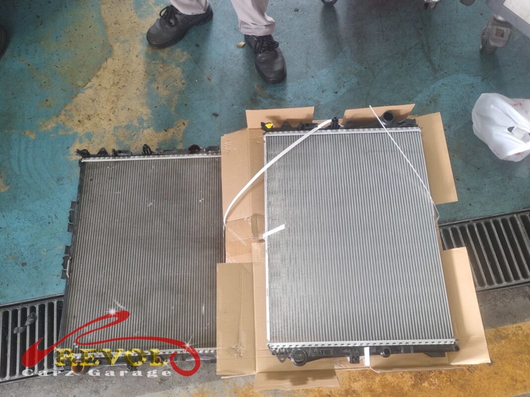 The old radiator removed from the S400L (left) beside the new Mercedes-spec replacement (right).