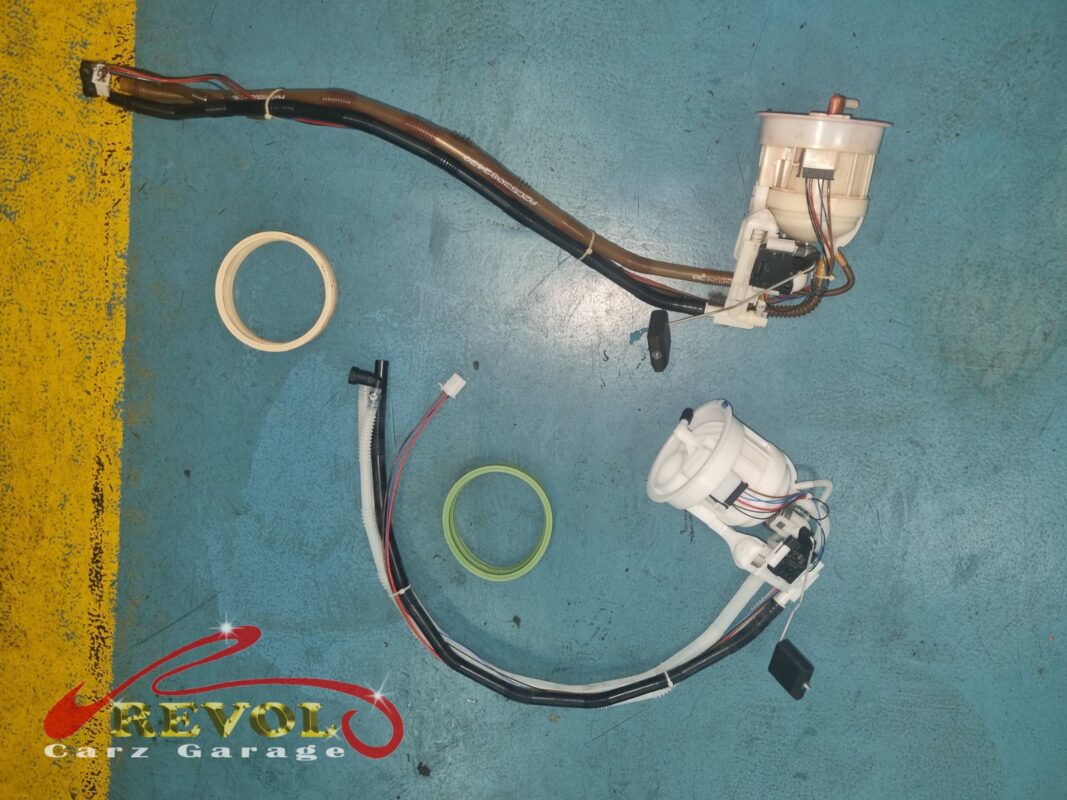 The old fuel pump and filter assembly (top, plastics yellowed) beside the new Mercedes-spec unit (bottom).