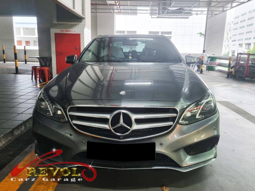 Mercedes-Benz E200 on the workshop lift for water pump replacement.