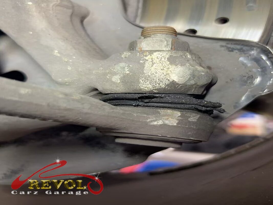 The old outer tie rod end, the rubber boot split and grease tracking out.