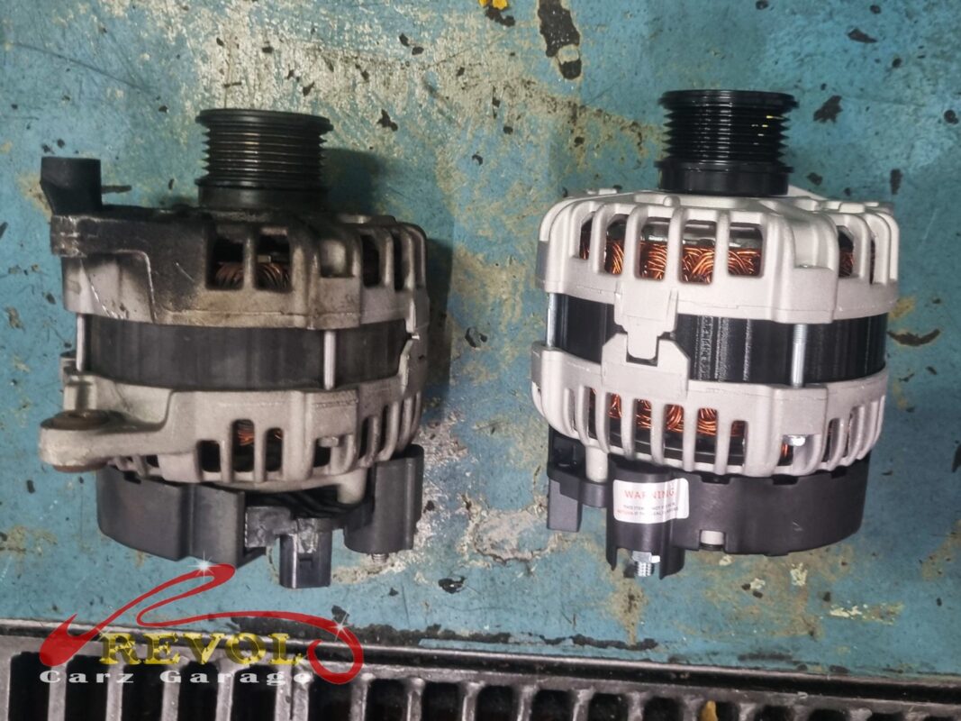 The old alternator (left, grimy) beside the new Mercedes-spec unit (right) with its overrunning pulley.
