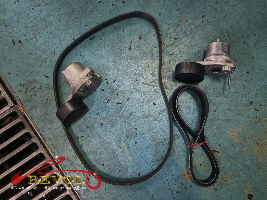 The old serpentine belt and tensioner (left) beside the new Mercedes-spec belt and tensioner (right), done with the alternator.