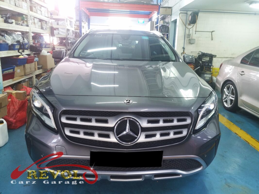 Mercedes-Benz GLA180 in the workshop with the front wheel off for wheel speed sensor replacement.