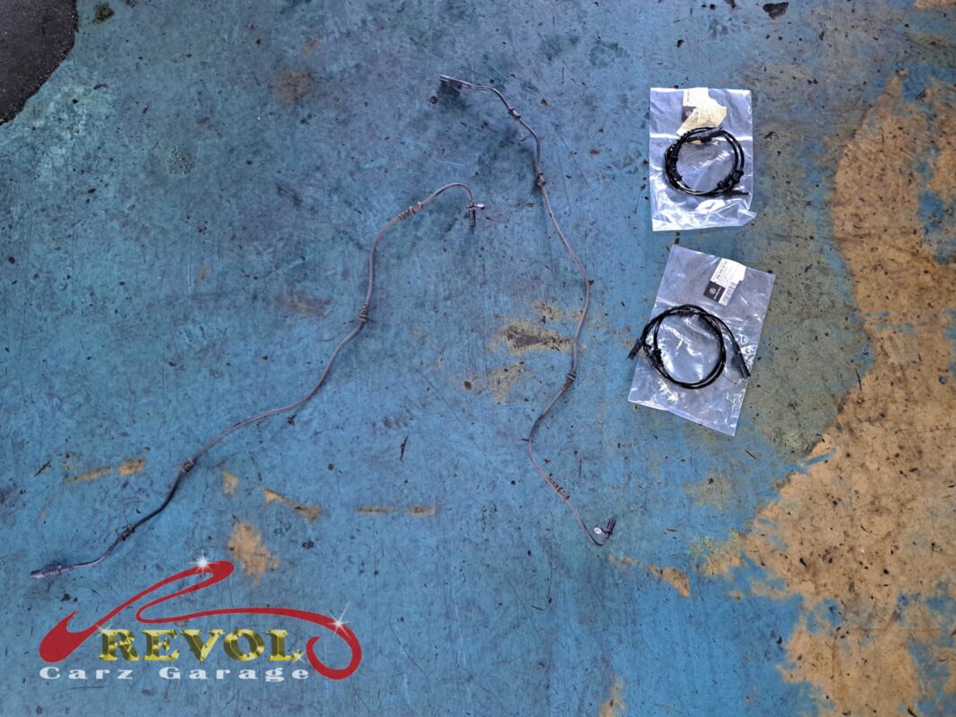 The old, corroded wheel sensor wiring (left) beside the new pair of Mercedes-spec sensors (right).