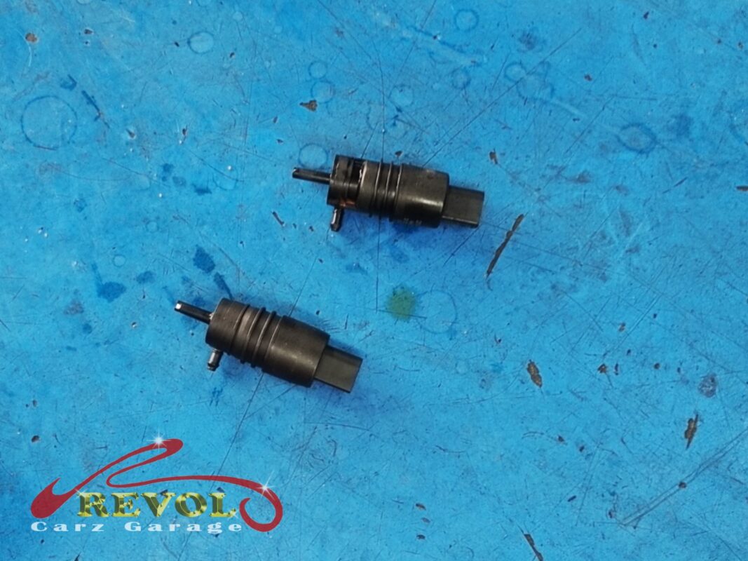 The old washer pump motor (top) beside the new Mercedes-spec replacement (bottom).