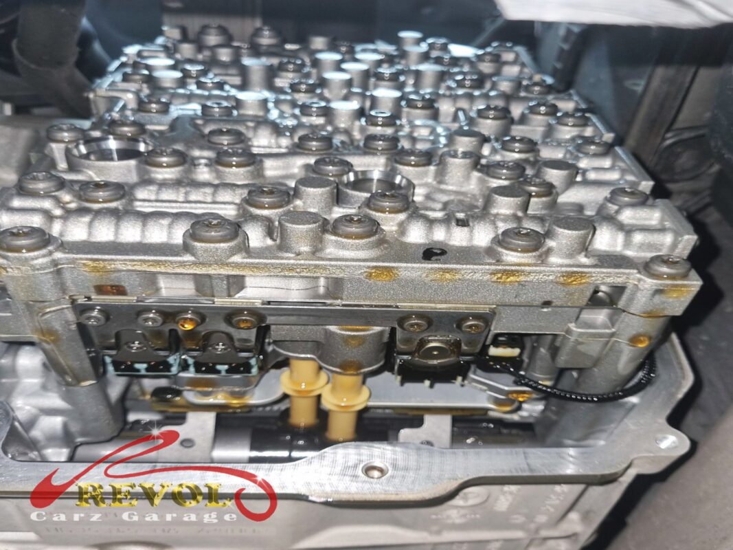 The gearbox internals exposed with the pan off, the valve body and its solenoids visible.